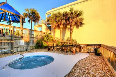 a backyard with a hot tub and a house at Blue Haven Villa in Panama City Beach