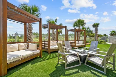 a patio with two gazebos and chairs and a table at Calypso Resort Tower 3 by Panhandle Getaways in Panama City Beach