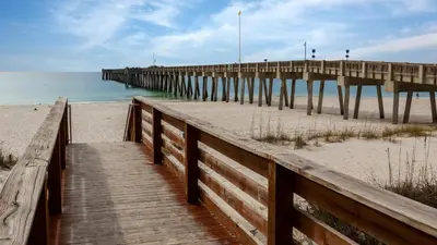 a wooden pathway to the beach with a pier at PARKING INCLUDED-Beachfront 2BD Ocean Villa! Gorgeous Amenities, Private Complex in Panama City Beach