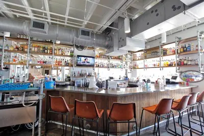 a bar with orange chairs in a restaurant at Prominence on 30A Pet Friendly Vacation Rentals by Panhandle Getaways in Watersound Beach