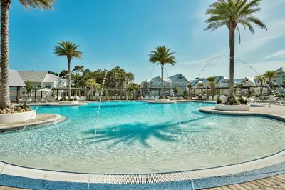 a large pool with a fountain in a resort at Prominence on 30A Pet Friendly Vacation Rentals by Panhandle Getaways in Watersound Beach