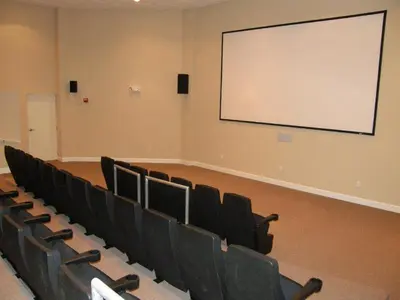 a lecture room with chairs and a white screen at Tidewater Beach Resort #2607 in Panama City Beach