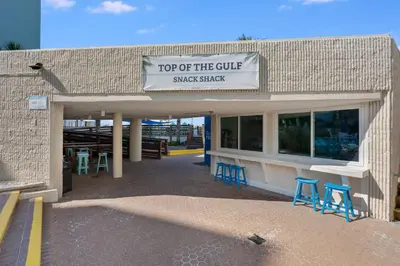a top of the cure snack shack with blue stools at Top Of The Gulf 111 in Panama City Beach