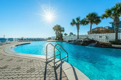 a swimming pool with a stairway leading into a resort at Majestic Beach Towers 1-1706 in Panama City Beach