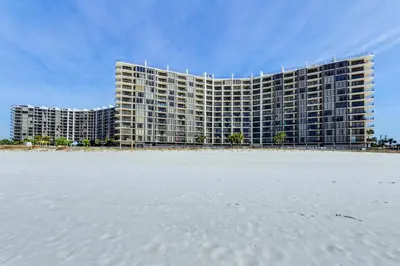a large building on the beach next to the sand at Edgewater Tower 2-407 in Panama City Beach