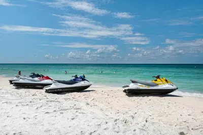 four speedboats are lined up on a beach at Calypso 1-2109 East in Panama City Beach