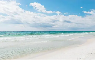 a sandy beach with the ocean in the background at Village of South Walton B375 in Seacrest