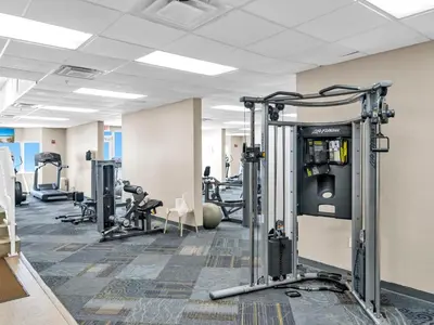 a gym with several treadmills and machines at Tidewater 1810 in Panama City Beach