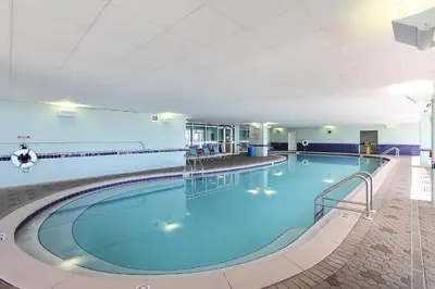 a large pool with blue water in a building at Majestic Beach Resort #204-2 by Book That Condo in Panama City Beach