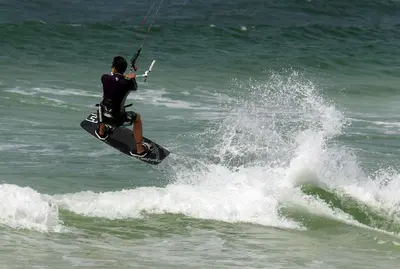 a man riding a wave on a board in the ocean at Tidewater 1909 in Panama City Beach