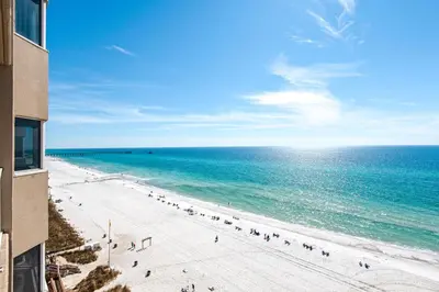a beach with people on it and the ocean at Tidewater 302 in Panama City Beach