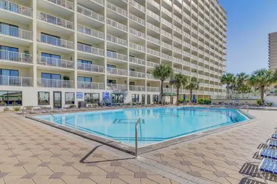 a swimming pool in front of a large apartment building at The Summit 924 in Panama City Beach