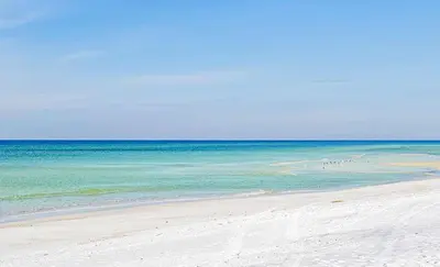 a beach with a group of people in the water at Top of the Gulf 610 in Panama City Beach