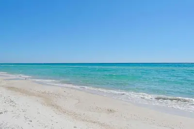 a sandy beach with the ocean in the background at Sunbird 412E in Panama City Beach