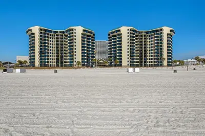 two tall buildings in the background of a beach at Sunbird 412E in Panama City Beach
