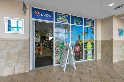 a restaurant with a sign in the front of a store at Majestic Beach Towers 1-1907 in Panama City Beach