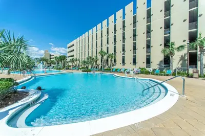 a swimming pool in front of a building at Emerald Beach 1035 in Panama City Beach