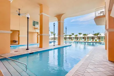 a swimming pool at a resort with blue water at Calypso 3-202 - The Sea Suite in Panama City Beach