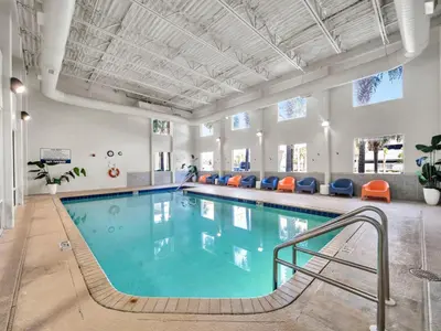 a pool in a large room with a swimming pool at Tidewater 607 in Panama City Beach