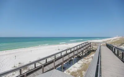 a boardwalk leading to a beach with the ocean at Prominence on 30A by Panhandle Getaways in Watersound Beach