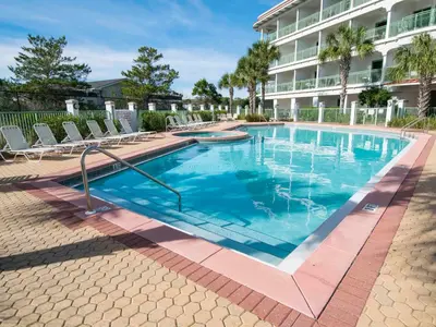 a swimming pool with chairs and a building at Inn at Seacrest #203 - 30A Get-A-Way in Rosemary Beach