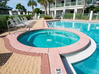 a large swimming pool in a resort with chairs around it at Inn at Seacrest #203 - 30A Get-A-Way in Rosemary Beach