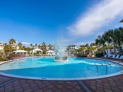 a large swimming pool with a fountain in the middle at Seabreeze Cabana in Rosemary Beach