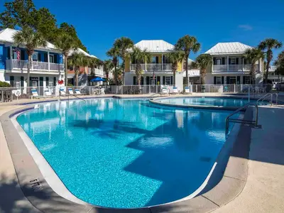 a large pool with blue water in a resort at Bungalows at Seagrove #147 in Seagrove Beach