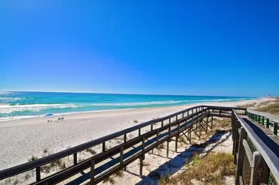 a boardwalk leading to a beach with the ocean at Seas The Day 30A in Santa Rosa Beach