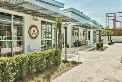 a building with a clock on the side of it at Prominence 30A - Hey Hey 30A in Inlet Beach