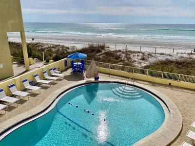 a swimming pool with a beach in the background at Continental 503 in Panama City Beach