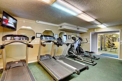 a gym with three treadmills and a treadmill at Summit Beach Resort #915 in Panama City Beach