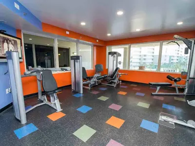 a gym with several treadmills and chairs in a room at Shores of Panama #1111 in Panama City Beach