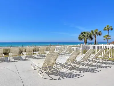 a group of chairs sitting on the beach at Long Beach Resort Tower III #905 in Panama City Beach