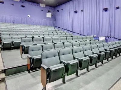 an empty auditorium with rows of chairs and purple curtains at Majestic Beach Towers I #1410 in Panama City Beach