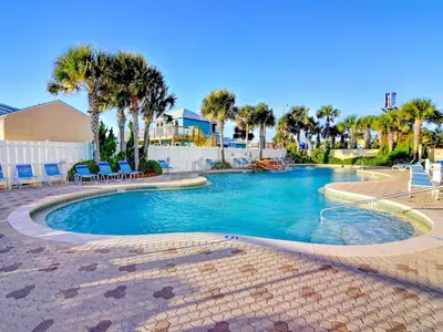 a swimming pool in a resort with palm trees at Majestic Beach Towers I #1410 in Panama City Beach