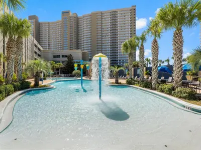 a pool with a fountain in front of a resort at Emerald Beach #1827 in Panama City Beach