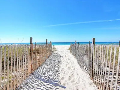 a fence on the beach next to the ocean at Long Beach Resort Tower IV #407 in Panama City Beach