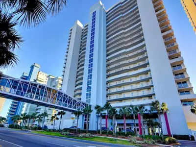 a tall building with a bridge in front of it at Majestic Beach Towers I #207 in Panama City Beach