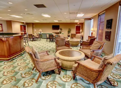 a waiting room with chairs and a table at Majestic Beach Towers I #207 in Panama City Beach