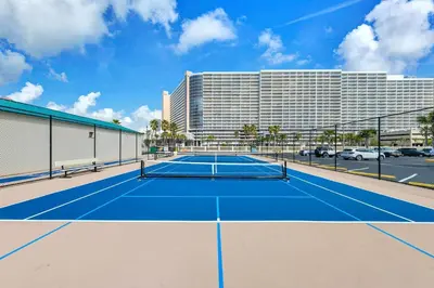 a tennis court in front of a hotel at Sunbird 211E in Panama City Beach