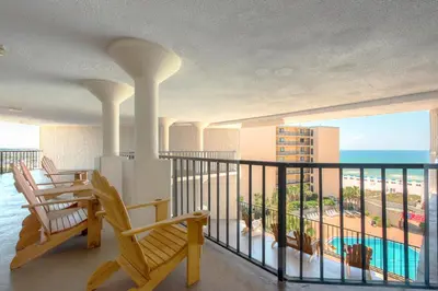 a balcony with chairs and a view of the beach at Top of the Gulf 208 in Panama City Beach