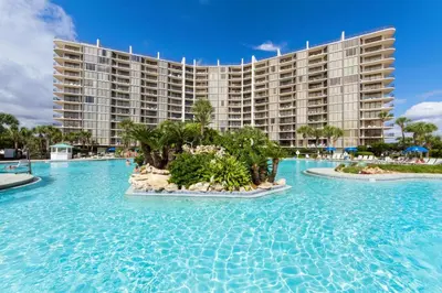 a resort with a pool in front of a building at Edgewater Golf Villa 2010 in Panama City Beach