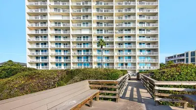 a large apartment building with benches in front of it at Beachcrest 1204 in Santa Rosa Beach