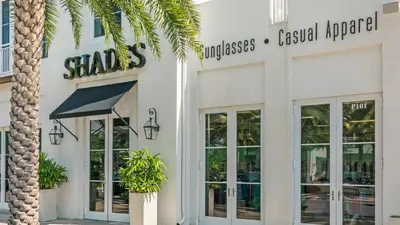 a store with a palm tree in front of it at Villas At Sunset Beach A302 - Sunset Villa in Rosemary Beach