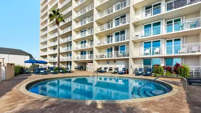 a swimming pool in front of a hotel at Beachcrest 601 in Santa Rosa Beach