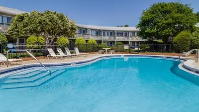 a large swimming pool with chairs and a building at Hidden Beach 117 in Santa Rosa Beach