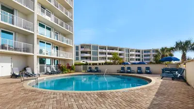 a swimming pool in front of a apartment building at Beachcrest 904 in Santa Rosa Beach