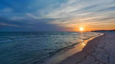 a sunset on a beach with the ocean at Beachcrest 1002 in Santa Rosa Beach