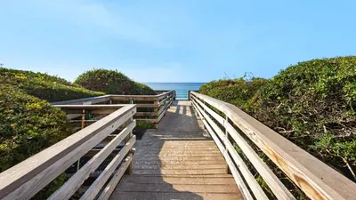 a wooden pathway leading to the ocean on a beach at Beachcrest 1002 in Santa Rosa Beach